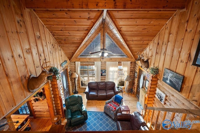 unfurnished living room with wood walls, wooden ceiling, log walls, wood-type flooring, and lofted ceiling with beams