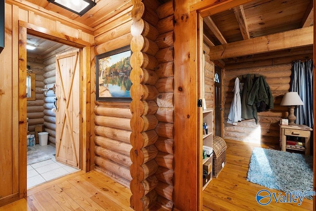 corridor featuring wood ceiling, light hardwood / wood-style flooring, log walls, and beamed ceiling