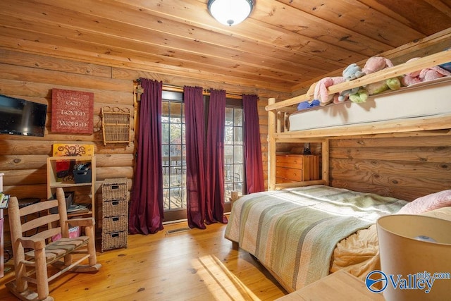 bedroom with rustic walls, wood ceiling, and hardwood / wood-style floors