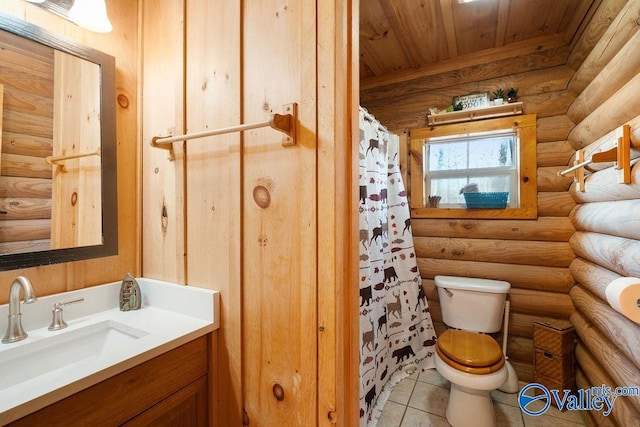 bathroom with toilet, wood ceiling, tile patterned floors, rustic walls, and vanity