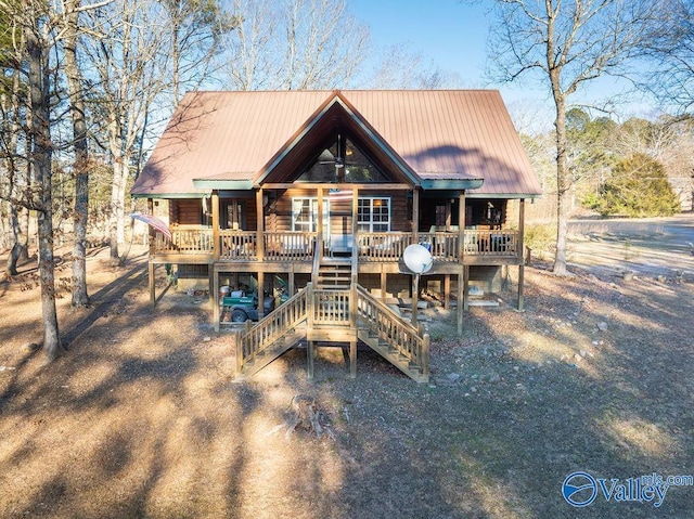 rear view of property featuring a wooden deck