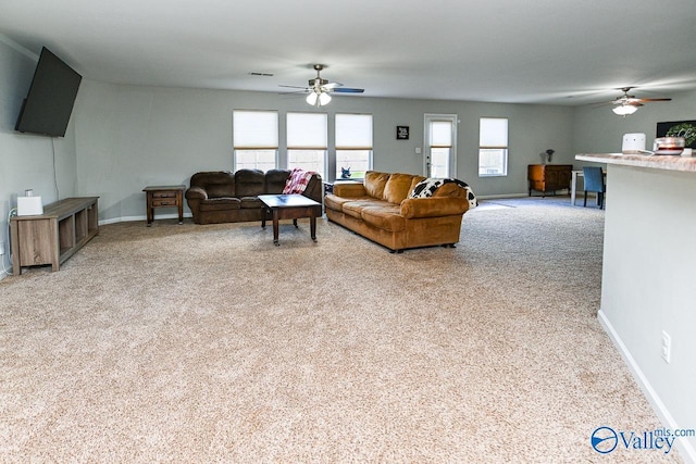 dining room featuring light carpet, ceiling fan, and baseboards