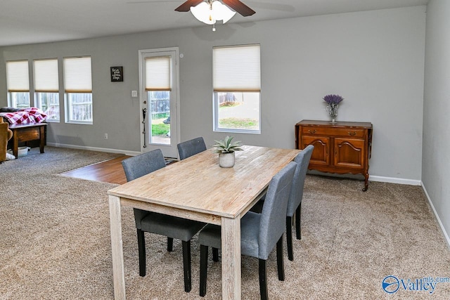 kitchen with a sink, light tile patterned floors, a peninsula, and dishwasher