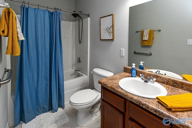 full bathroom featuring tiled shower, a sink, baseboards, and double vanity