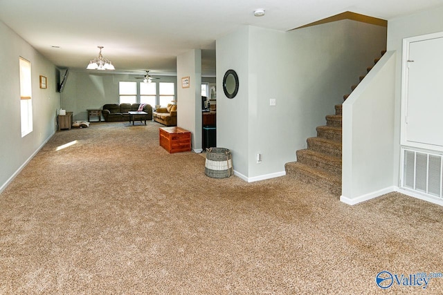 living room with a ceiling fan and light colored carpet