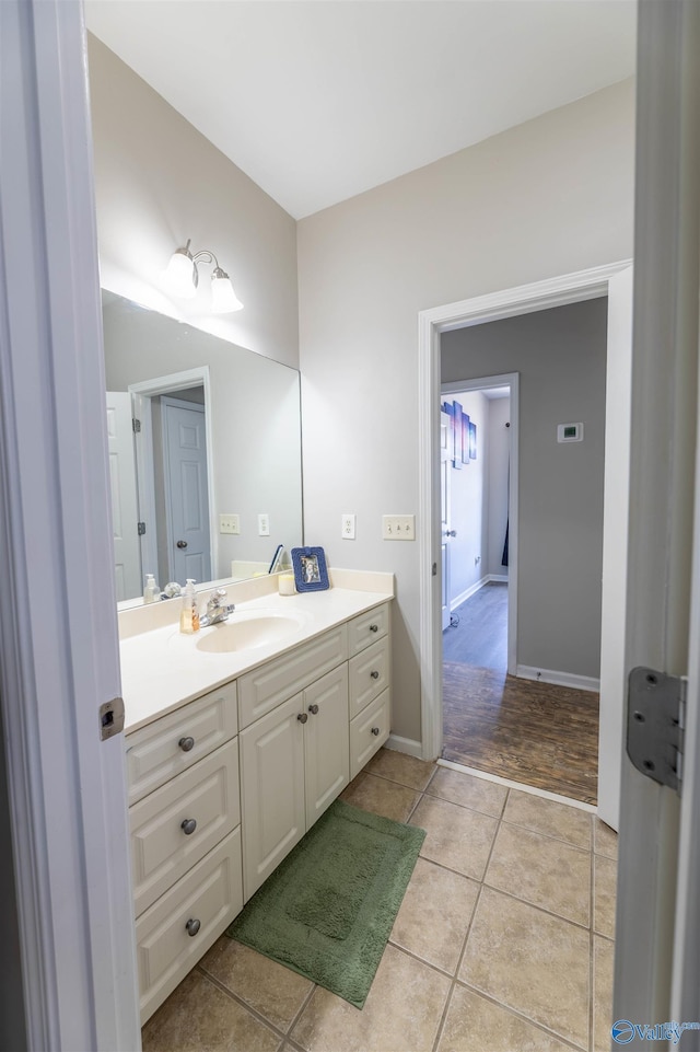 bathroom with tile patterned flooring, vanity, and baseboards