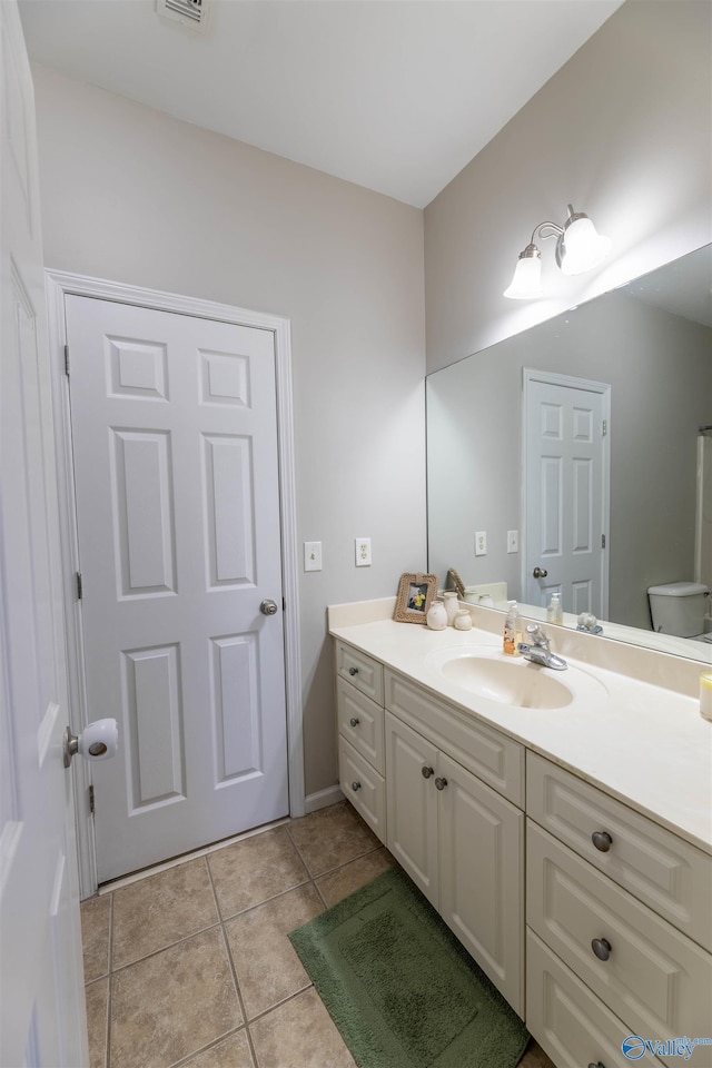 bathroom featuring tile patterned floors, visible vents, and vanity