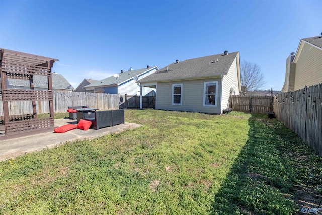 rear view of house with a lawn, a fenced backyard, and a pergola