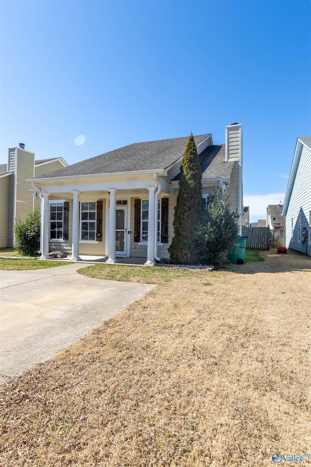 view of front of property featuring a chimney and fence