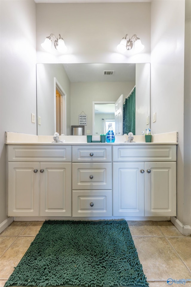 bathroom featuring tile patterned floors, visible vents, baseboards, and vanity