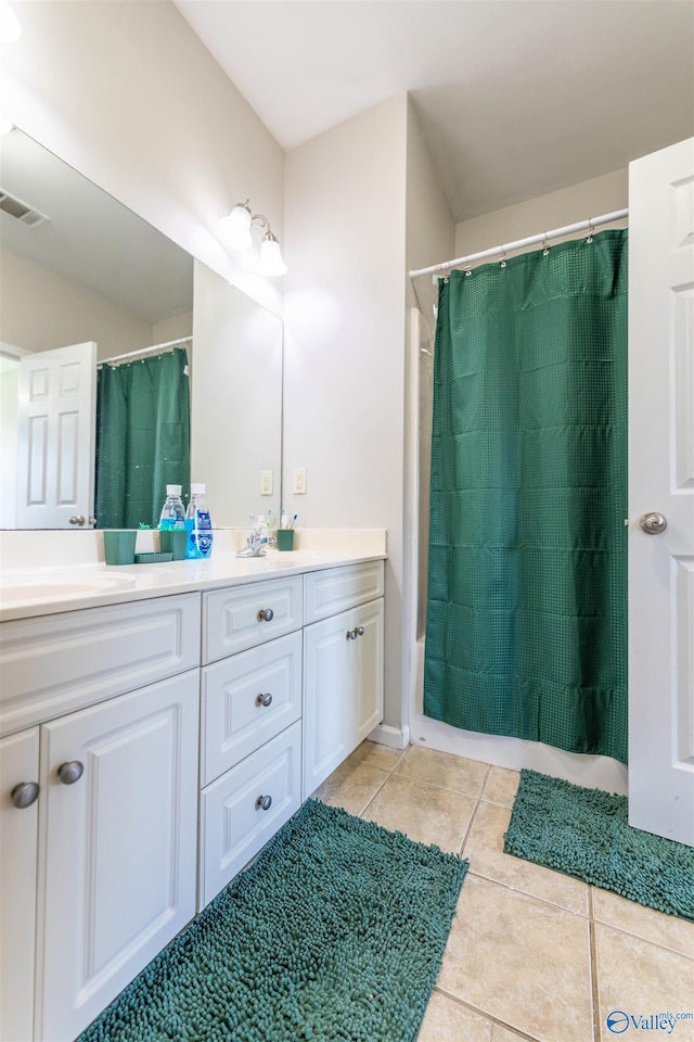 full bathroom with tile patterned flooring, double vanity, visible vents, and a sink