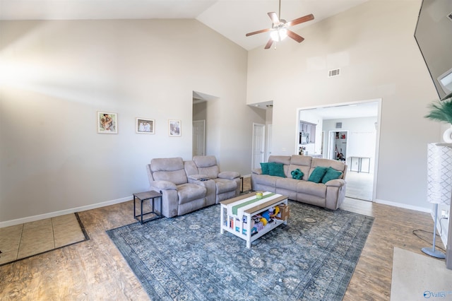 living area with visible vents, baseboards, and wood finished floors