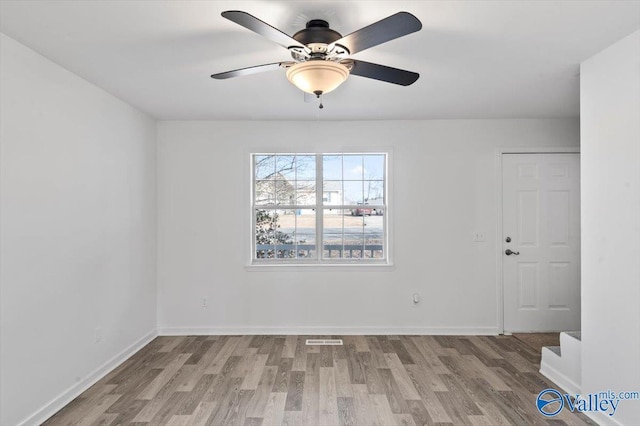 empty room with ceiling fan and light wood-type flooring