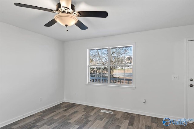 empty room with dark wood-type flooring and ceiling fan