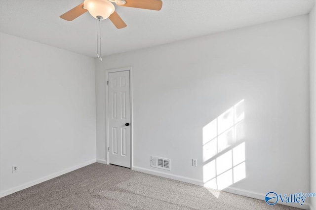 unfurnished room featuring ceiling fan and light carpet