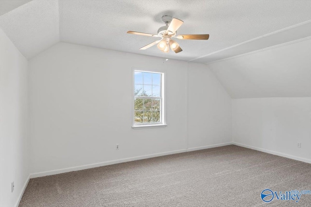 additional living space with ceiling fan, carpet, lofted ceiling, and a textured ceiling