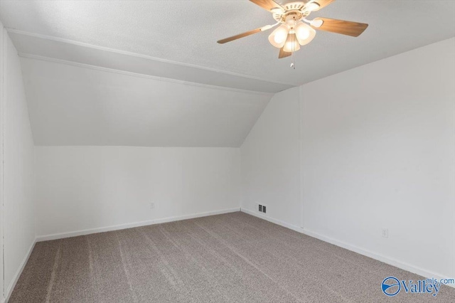 additional living space featuring ceiling fan, lofted ceiling, and carpet floors