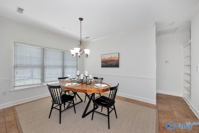 119 Cannes Dr, Brownsboro, AL 35741 - tiled dining area with crown molding, built in shelves, and a chandelier