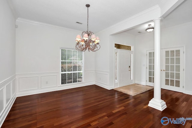 119 Cannes Dr, Brownsboro, AL 35741 - unfurnished dining area with decorative columns, crown molding, wood finished floors, a chandelier, and a wainscoted wall