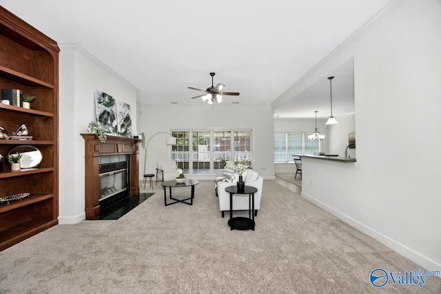 119 Cannes Dr, Brownsboro, AL 35741 - carpeted living room with a ceiling fan, a fireplace, crown molding, and a chandelier