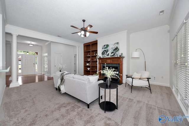119 Cannes Dr, Brownsboro, AL 35741 - living area with light colored carpet, ceiling fan, ornate columns, built in shelves, and a fireplace