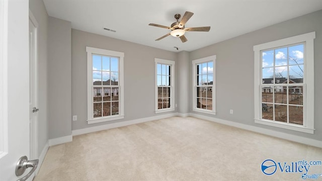 empty room with light carpet and ceiling fan