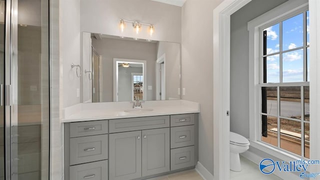 bathroom featuring vanity, tile patterned floors, and toilet