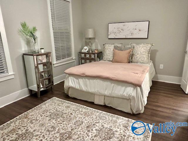 bedroom featuring dark wood-type flooring