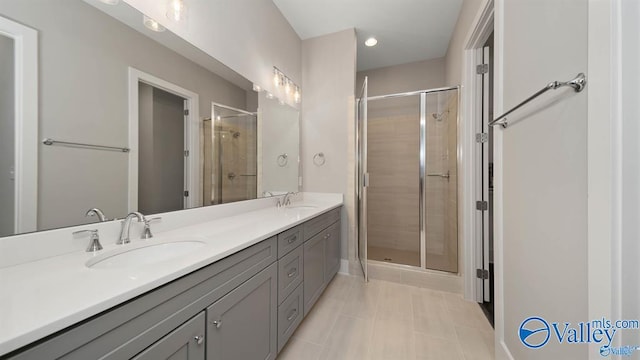 bathroom featuring vanity, an enclosed shower, and tile patterned floors