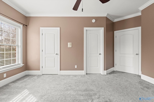 unfurnished bedroom featuring crown molding, light colored carpet, and ceiling fan