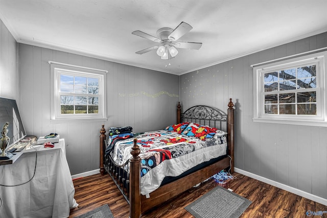 bedroom with baseboards, wood finished floors, a ceiling fan, and crown molding