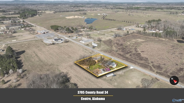 birds eye view of property with a rural view