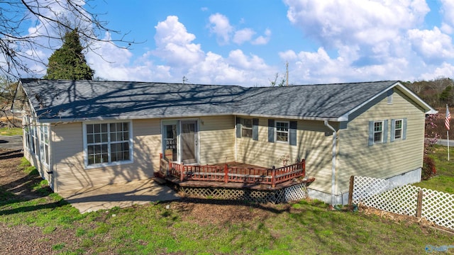 rear view of property featuring crawl space, roof with shingles, and a wooden deck