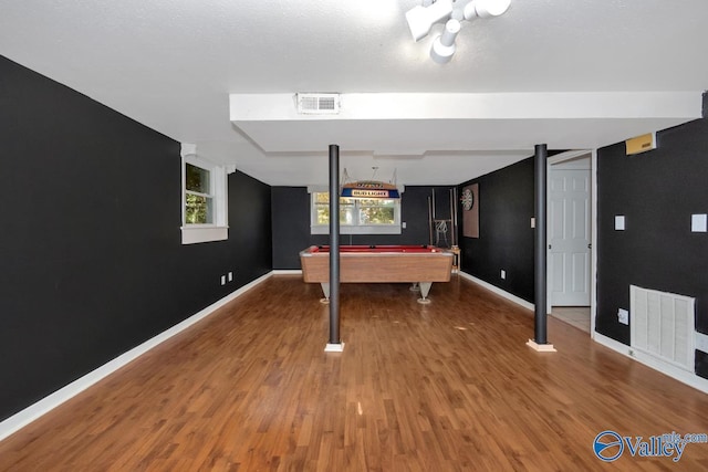 game room featuring wood-type flooring, a textured ceiling, and pool table