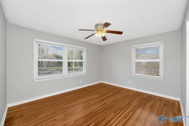 spare room with ceiling fan and hardwood / wood-style floors