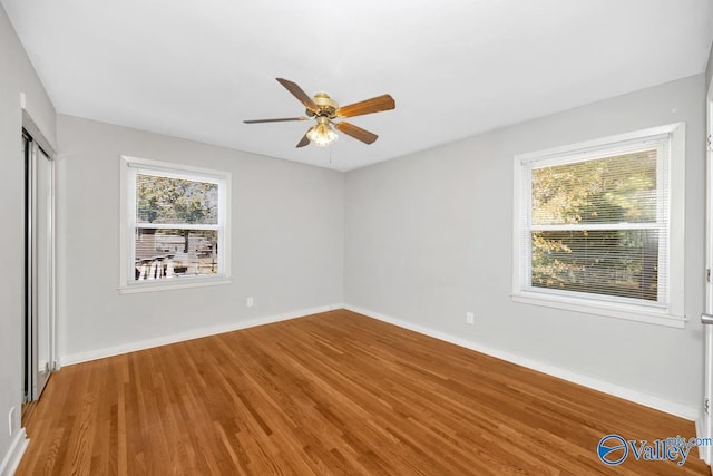 empty room featuring ceiling fan and wood-type flooring