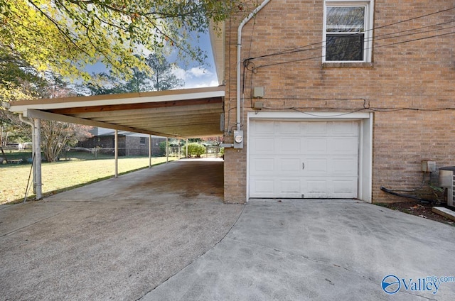 garage featuring a carport and a lawn