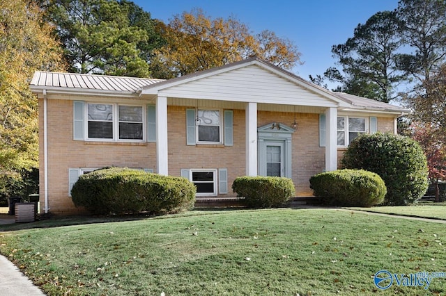 raised ranch with a front yard