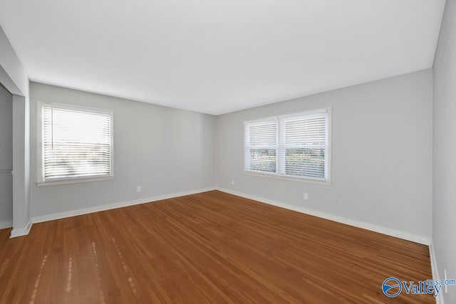 unfurnished room featuring hardwood / wood-style floors and plenty of natural light