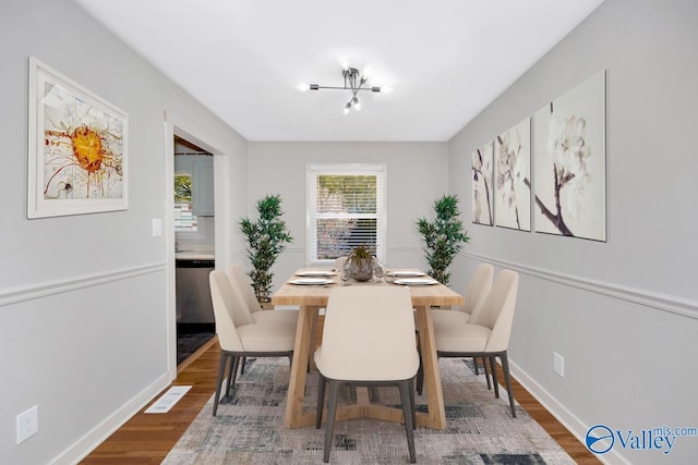 dining space with a notable chandelier and dark wood-type flooring