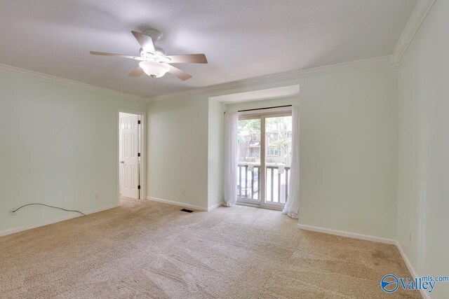 unfurnished room featuring light colored carpet, ornamental molding, and ceiling fan