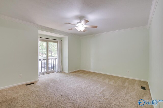 carpeted empty room with crown molding and ceiling fan