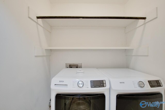 clothes washing area featuring independent washer and dryer