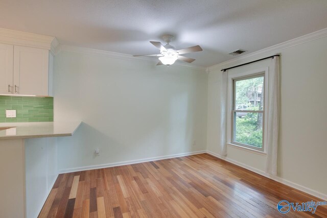 unfurnished room with crown molding, ceiling fan, and light hardwood / wood-style flooring