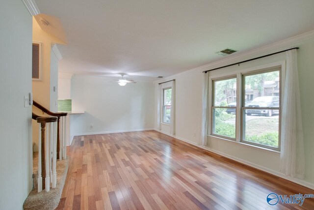 unfurnished living room featuring crown molding, light hardwood / wood-style floors, and ceiling fan