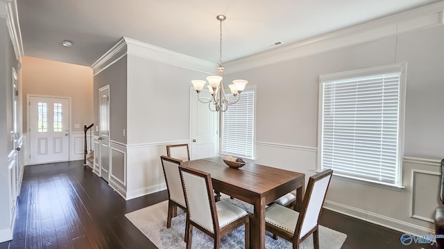 7607 NW Ashor Dr, Huntsville, AL 35806 - dining room featuring a chandelier, dark wood-type flooring, a decorative wall, a wainscoted wall, and crown molding