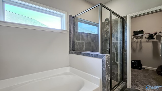 7607 NW Ashor Dr, Huntsville, AL 35806 - full bathroom with a stall shower, a bath, and a spacious closet