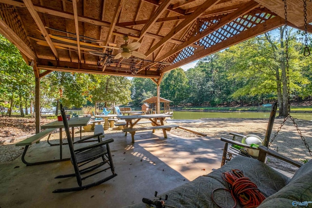 view of patio featuring a gazebo, a water view, and ceiling fan