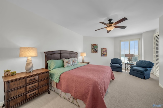 bedroom with light carpet and a ceiling fan