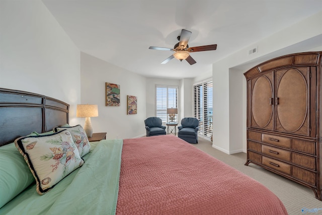 bedroom with ceiling fan, visible vents, baseboards, and light colored carpet